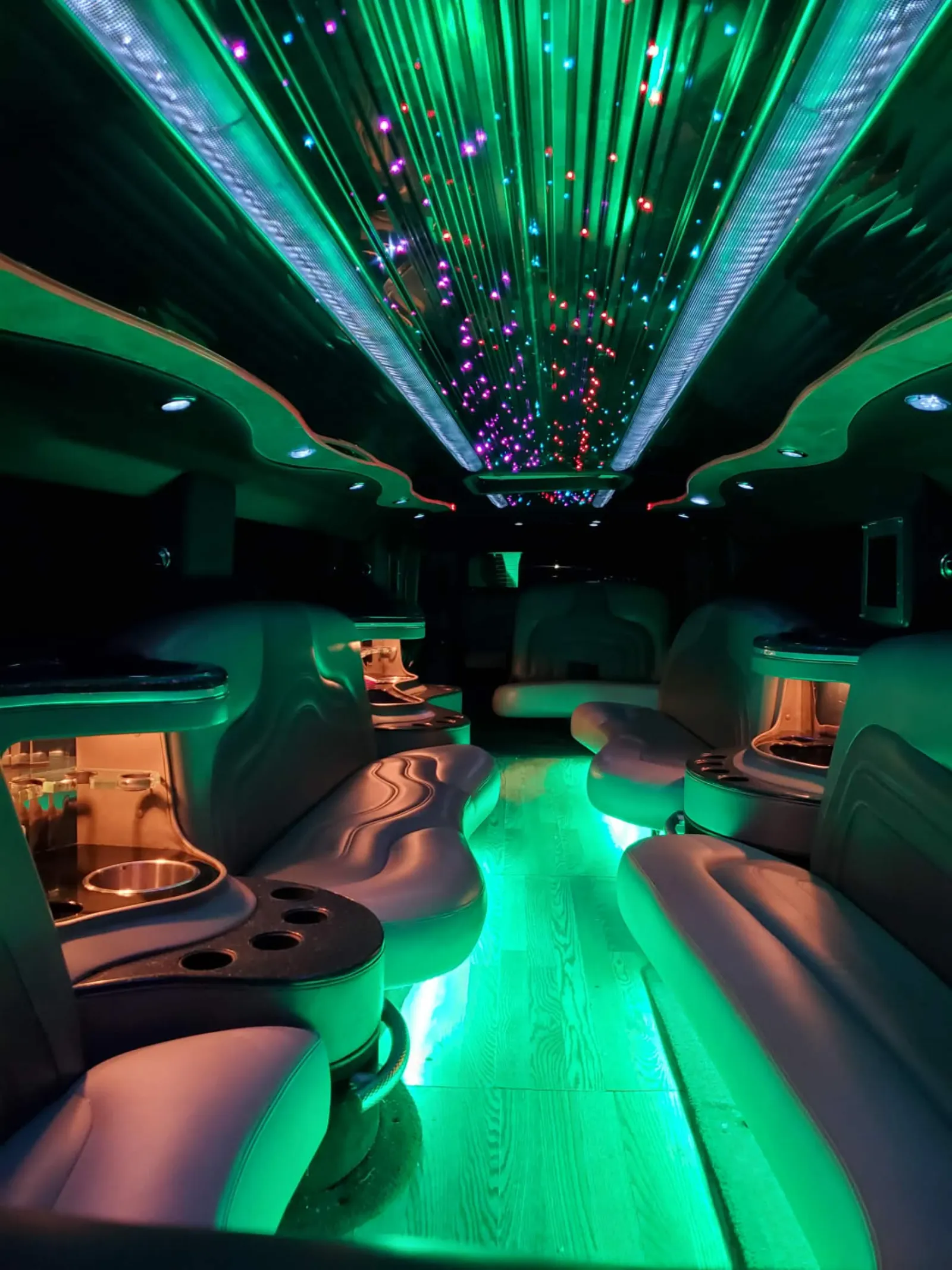 Hummer stretch interior with green starlight ceiling and lounge seating