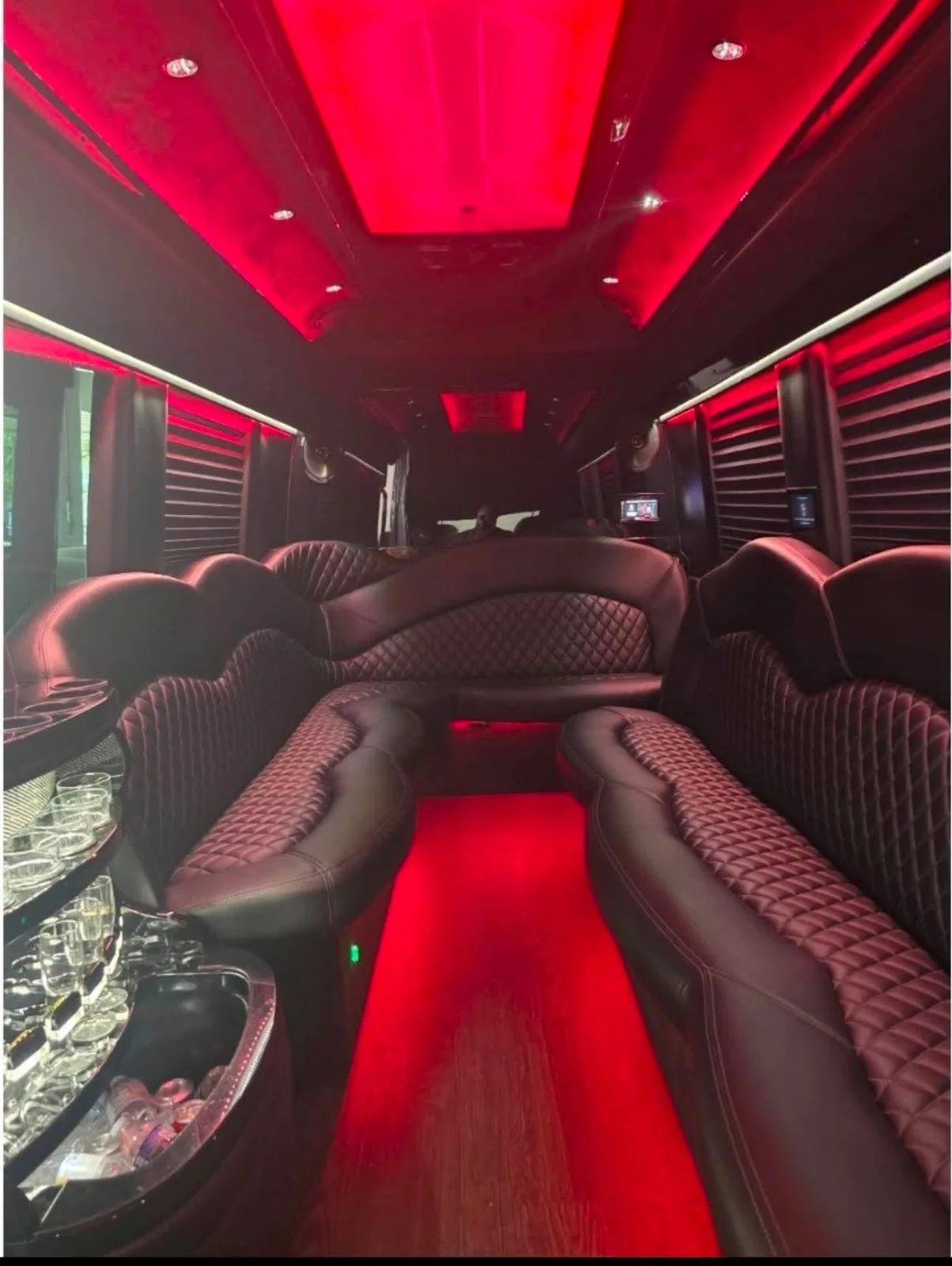 Sprinter limo lounge seating and bar with red lighting