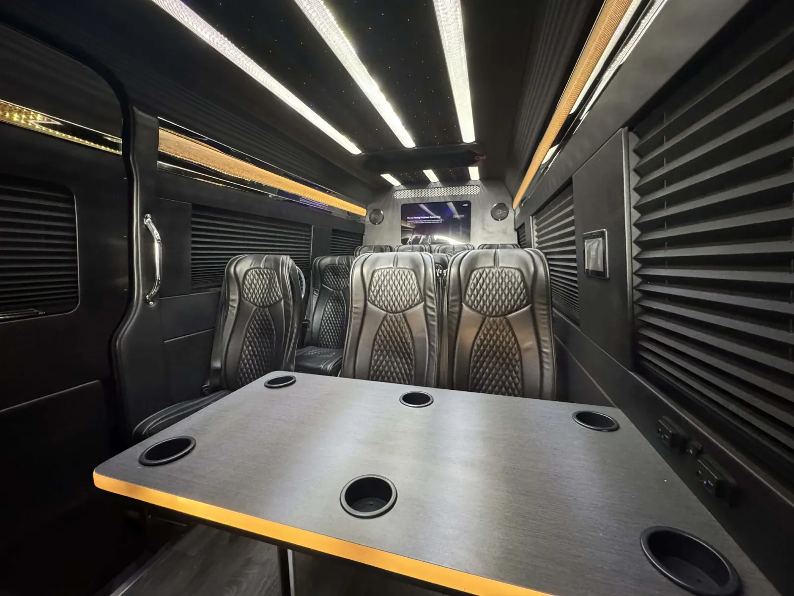 Sprinter limo executive interior facing the front table and seats