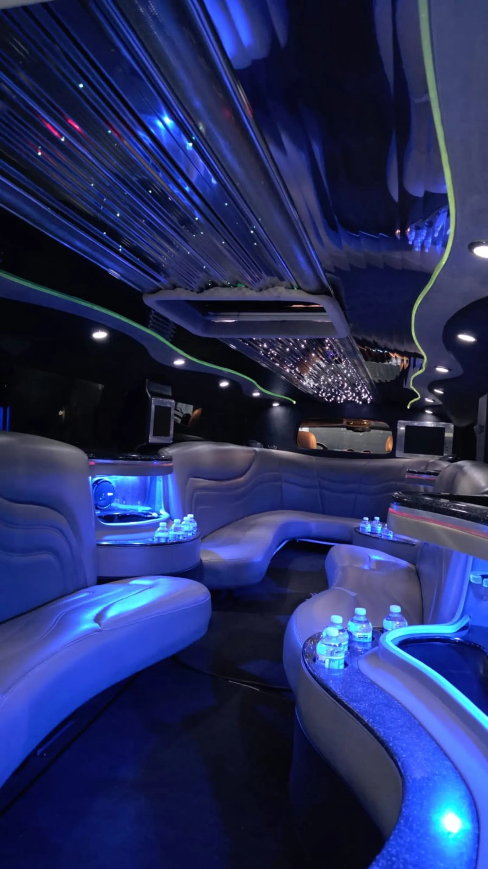 Stretch limo interior in deep blue with starlight ceiling and bars