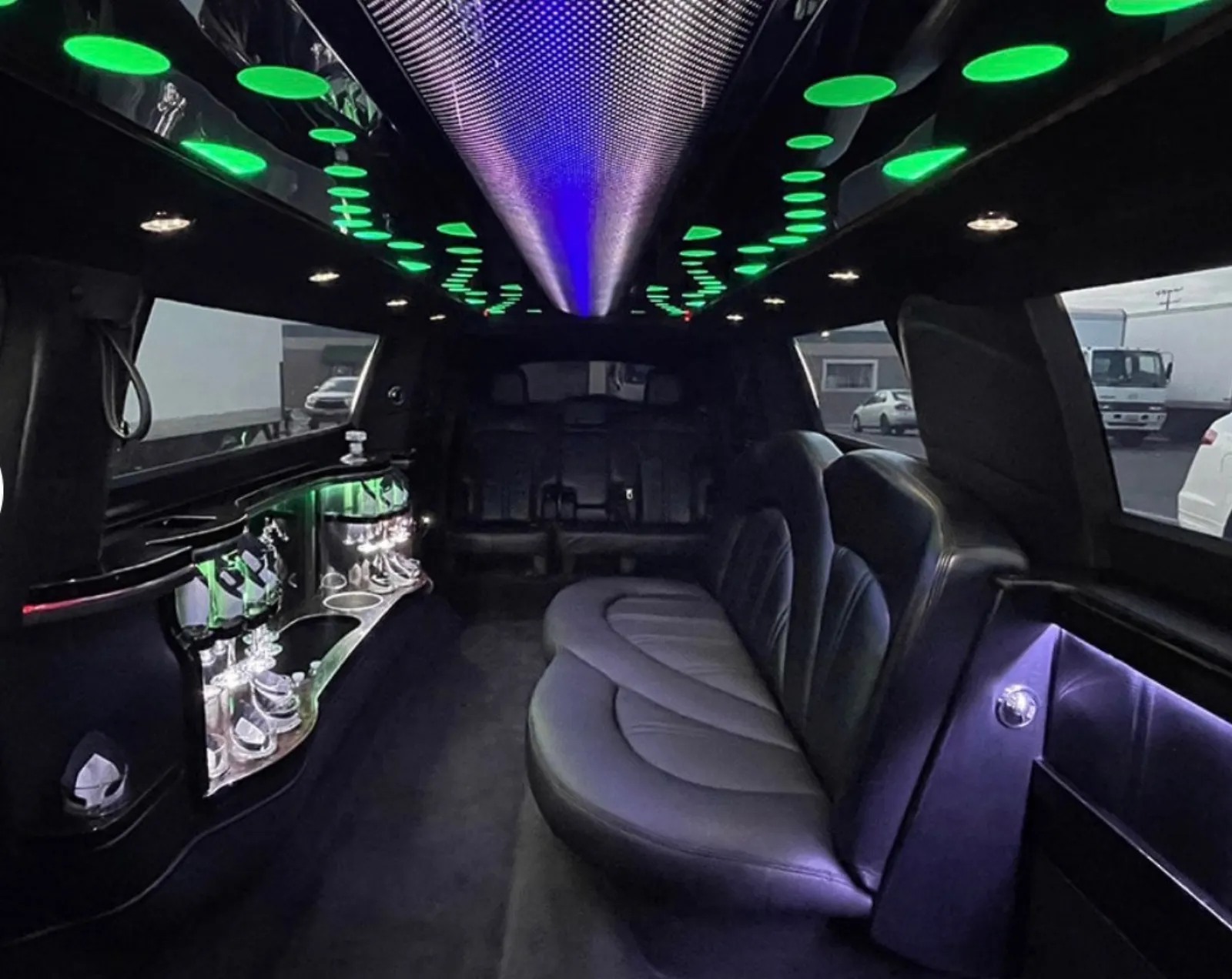 Lincoln MKT stretch interior with green ceiling lights and bar