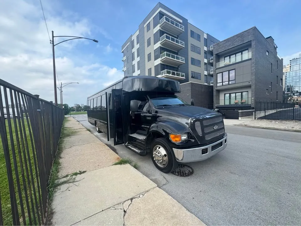 Black party bus parked along a city street