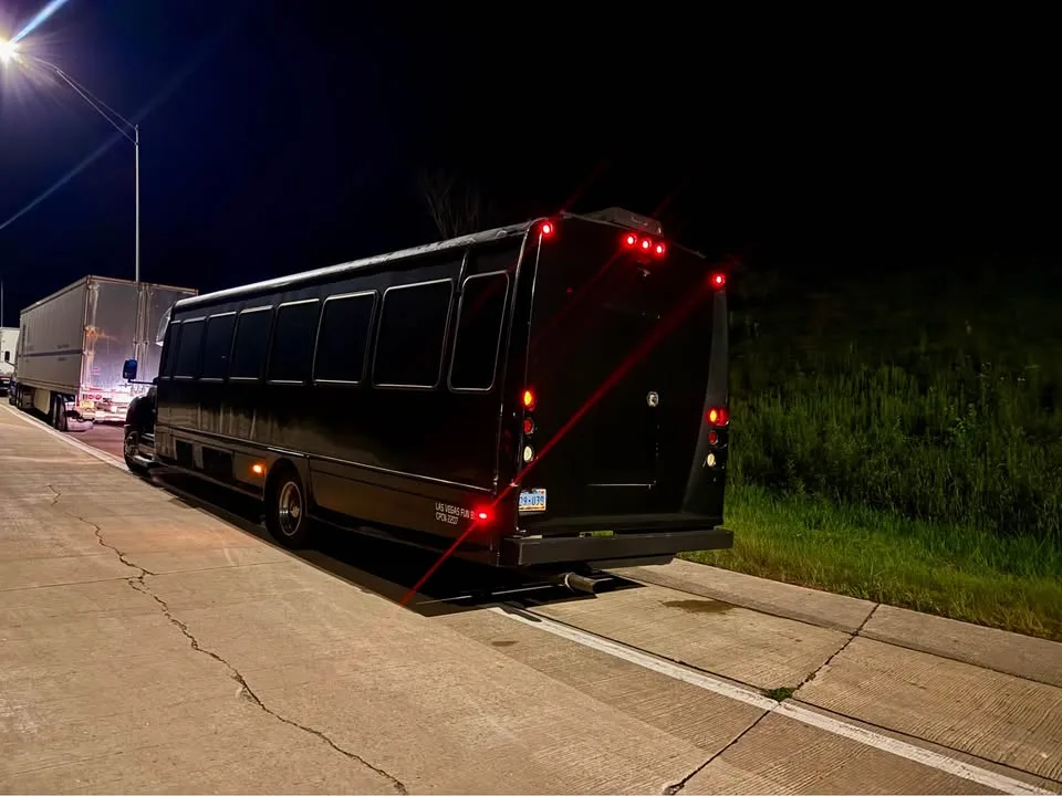 Black party bus rear view at night