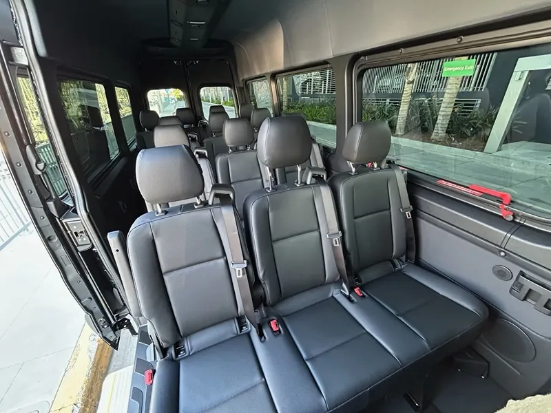 Sprinter van interior with rows of black leather seats