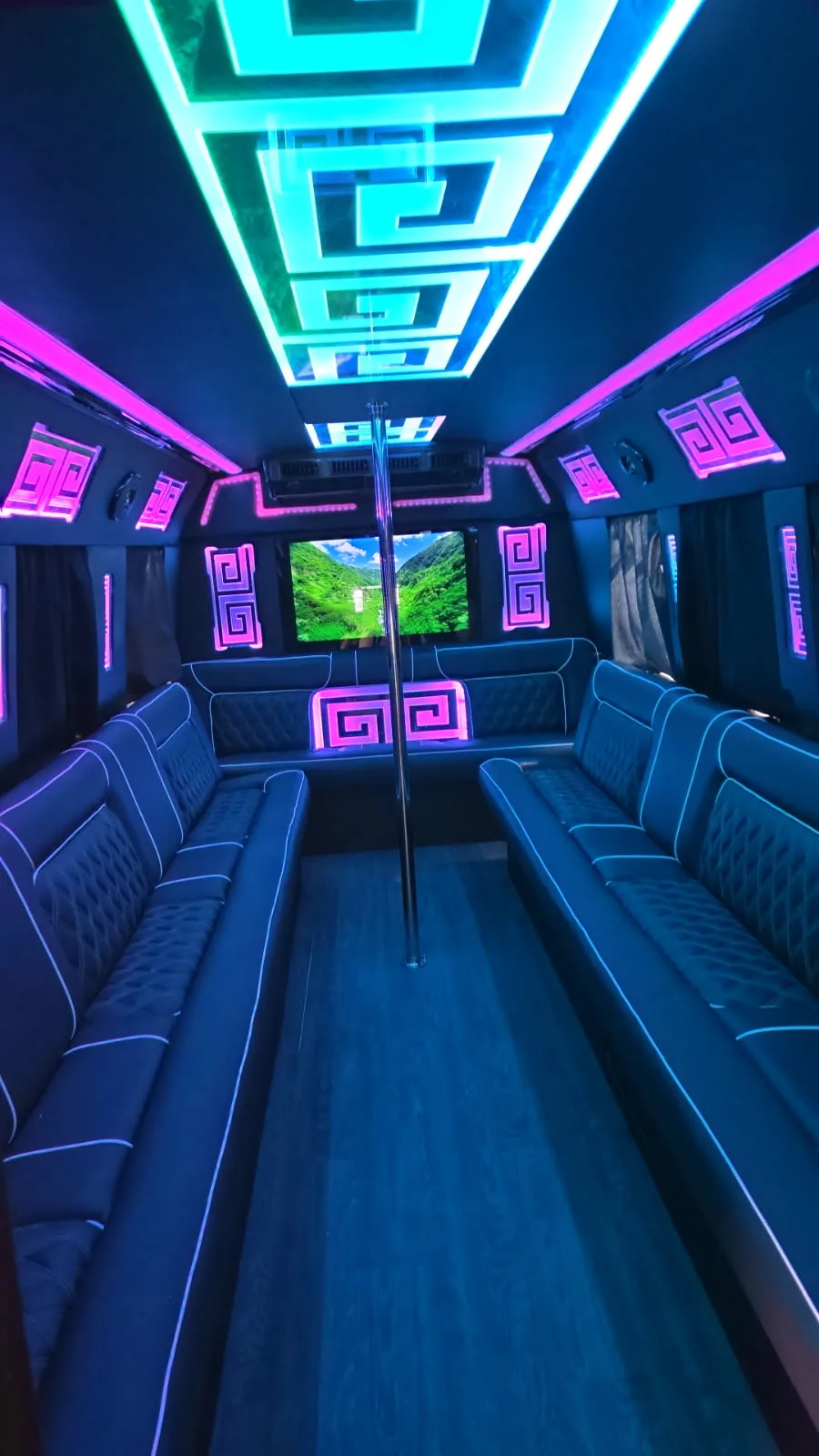 Party bus interior with teal and pink lighting