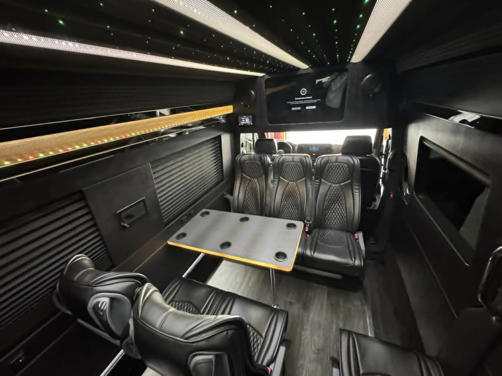 Sprinter limo executive interior with leather seats and table