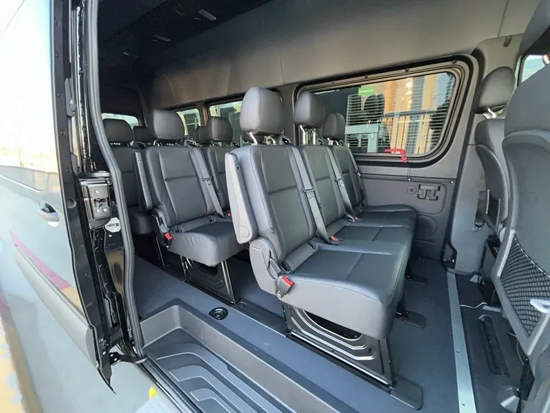 Sprinter van interior showing three rows of leather seats
