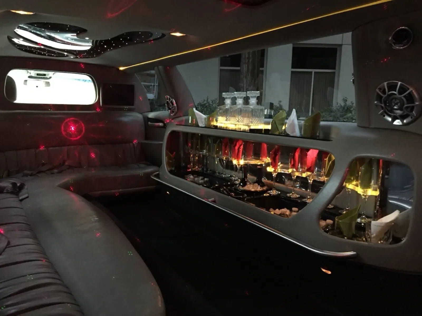Stretch limo bar area with glasses and red accent lighting