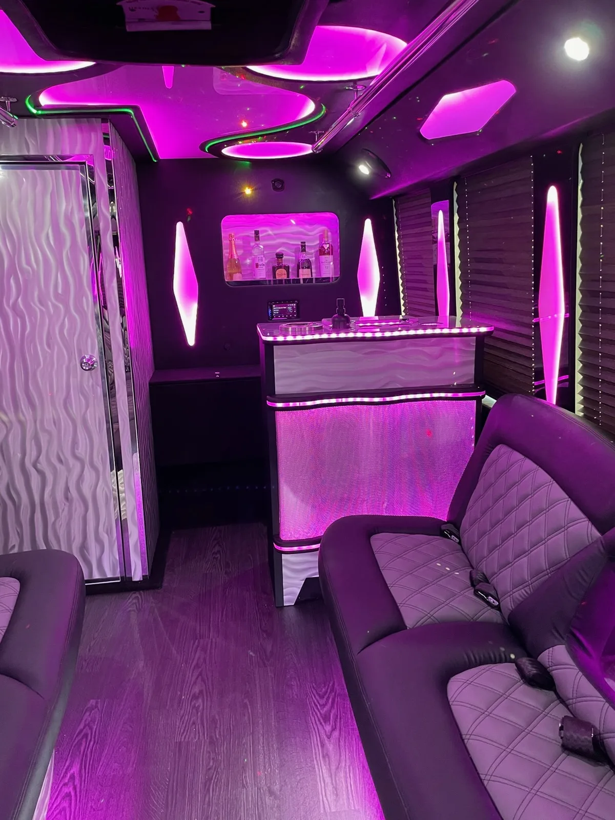Party bus bar area lit in pink and purple