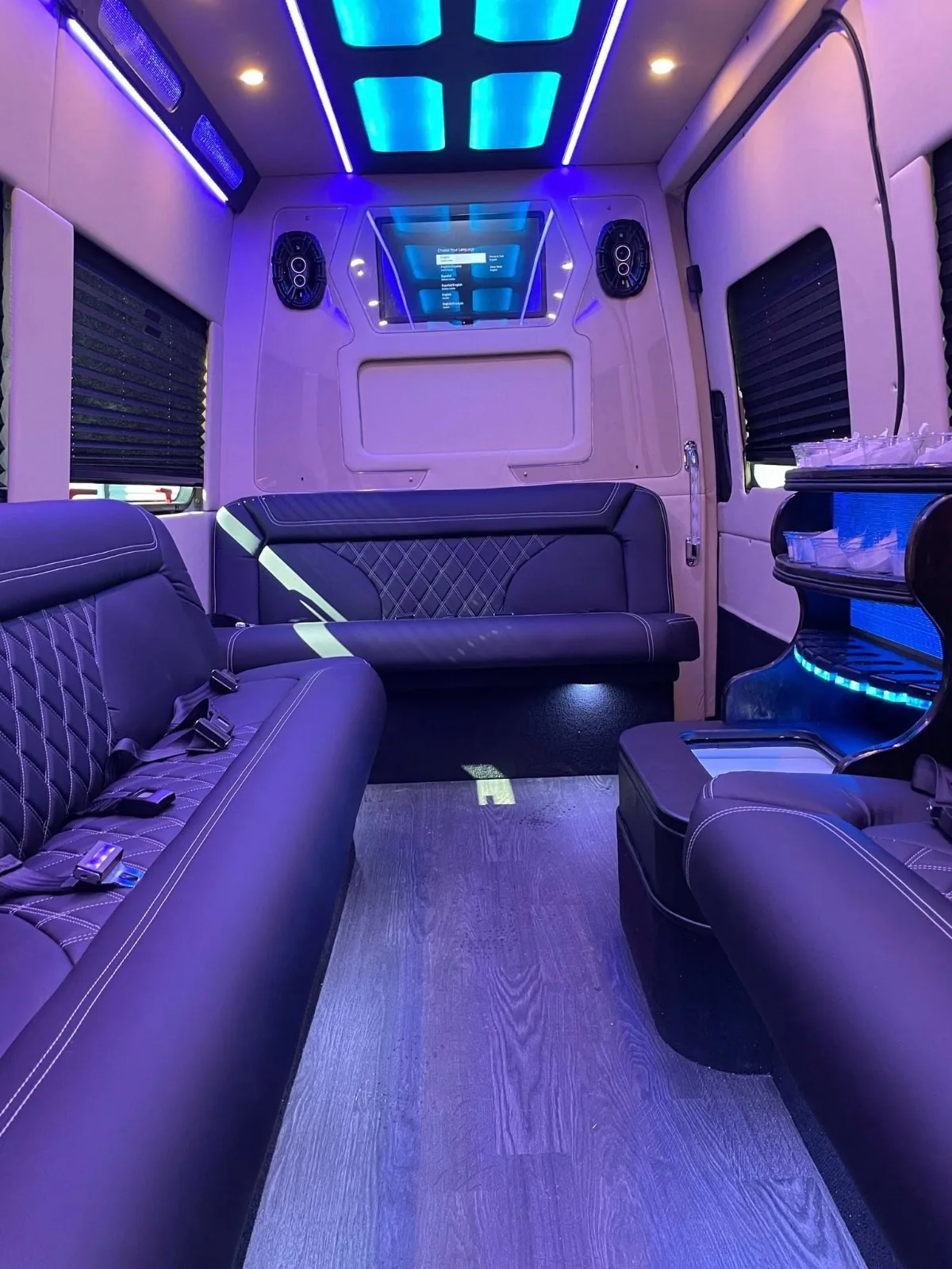 Sprinter limo seating and illuminated ceiling in a white interior